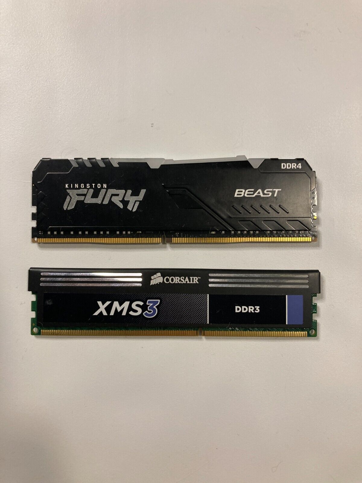 Two sticks of PC RAM Kingston Fury DDR4 8GB and Corsair XMS3 DDR3 2GB